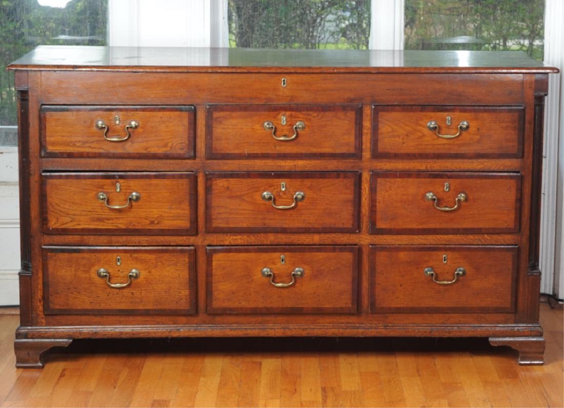 Oak Chest of Drawers: Faux lock over three drawers with faux locks over three drawers with faux locks over three drawers with real locks. Provenance: Formerly from the estate of Harry T. Peters Jr., of "Wyndholme", Orange