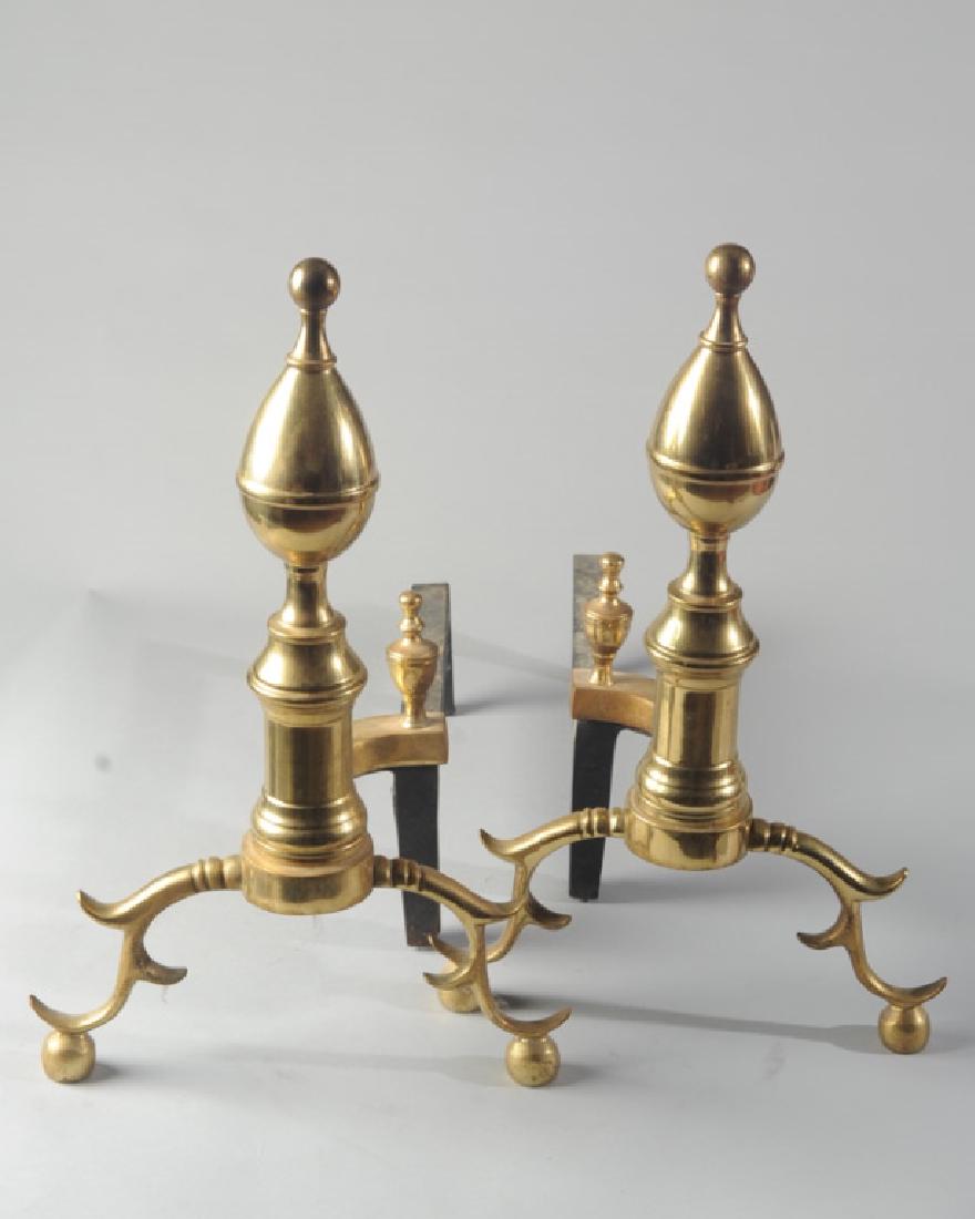 Harvin Co. Brass Andirons: Colonial style, spurred brass feet. Approx. 20" height, 22" long. Provenance: Formerly from the estate of Harry T. Peters Jr., of "Wyndholme", Orange County, Virginia.