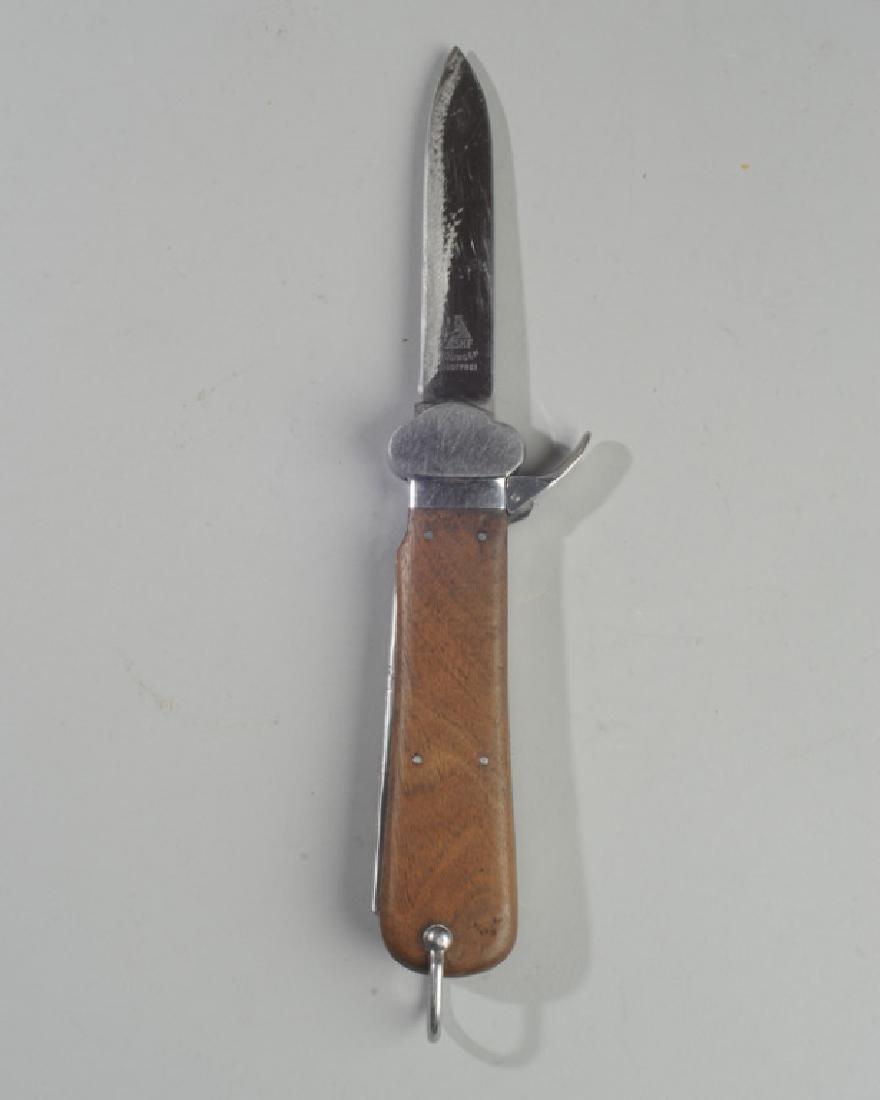 WWII German Paratrooper's Gravity Knife: WWII German Luftwaffe Fallschirmjager knife, blade marked SMF Solingen Rostfrei, previous owner's name scratched into side, working. L: approx. 10 1/4" open.