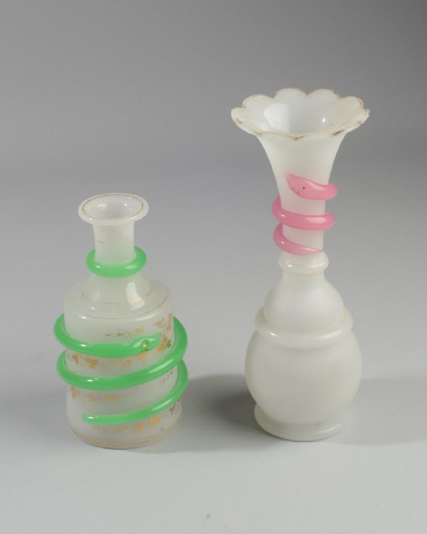 2 Bohemian Opaline Glass Vases w Snake Decor: Taller vase has trumpet shaped mouth rising out of bulbous body, with polished glass rings alternating with frosted glass body, neck wrapped by a pink glass snake. Smaller in bottle shape with gold pa