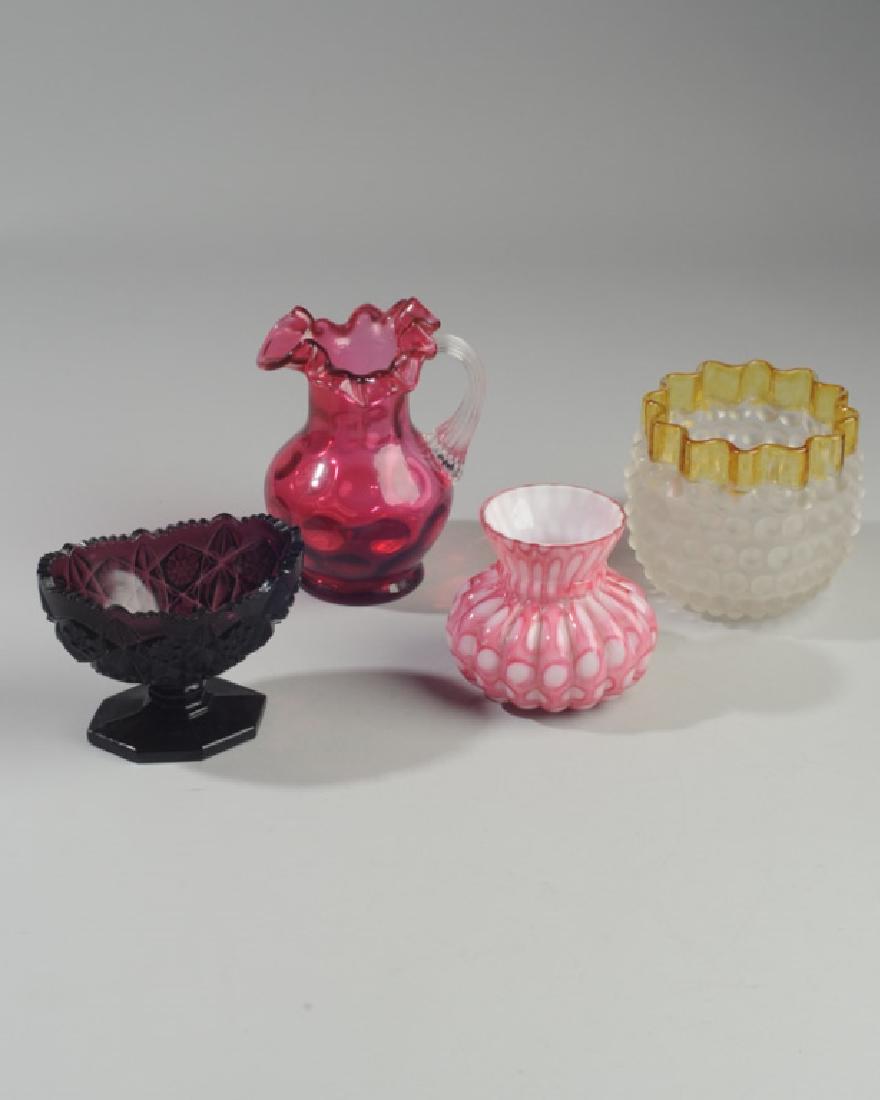Lot of Five Art Glass Items: Hobnailed vase (minor chipping), lobed pink and white cased glass vase with flared rim, cranberry optic glass pitcher, patterned purple glass compote, and a 19th c blue glass vase with enameled peacoc