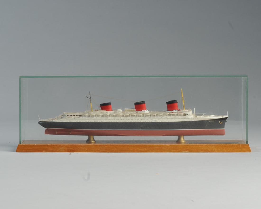 Normandie Ship Model: Elaborately detailed in display case, brass plaque "Normandie Chantiers et Ateliers de St. Nazaire 1935." Not examined out of case, probably diecast. L: approx. 9 1/2". H: approx. 2 1/4".