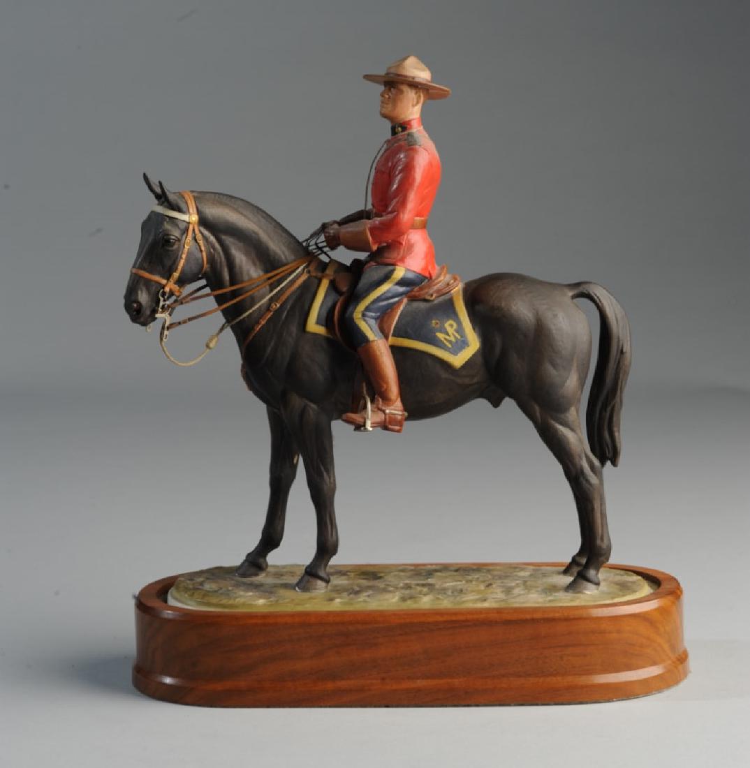 Royal Worcester Canadian Mounted Police: Exceptional figure of Royal Canadian Mounted Policeman on horseback, made by Royal Worcester and modeled by Doris Lindner and dated 1966, on fitted wooden stand. Damaged hat. H: approx. 11".