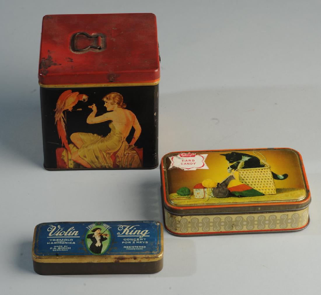 3 Advertising Tins: Violin King Harmonica (empty), Sharp's Candy and woman with parrot. Tallest: approx. 5".