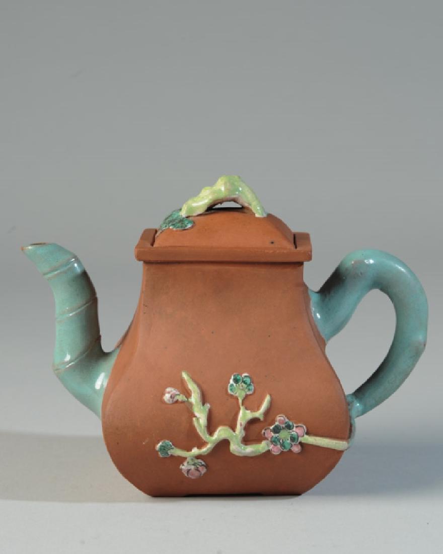 Chinese Yixing Enamel Teapot: Unglazed red yixing clay teapot with enameled decoration of bamboo and prunus. Bulbous rectangular form. Incised square character mark to base. Some pleasing craquelure to enamels. Interior darkening 