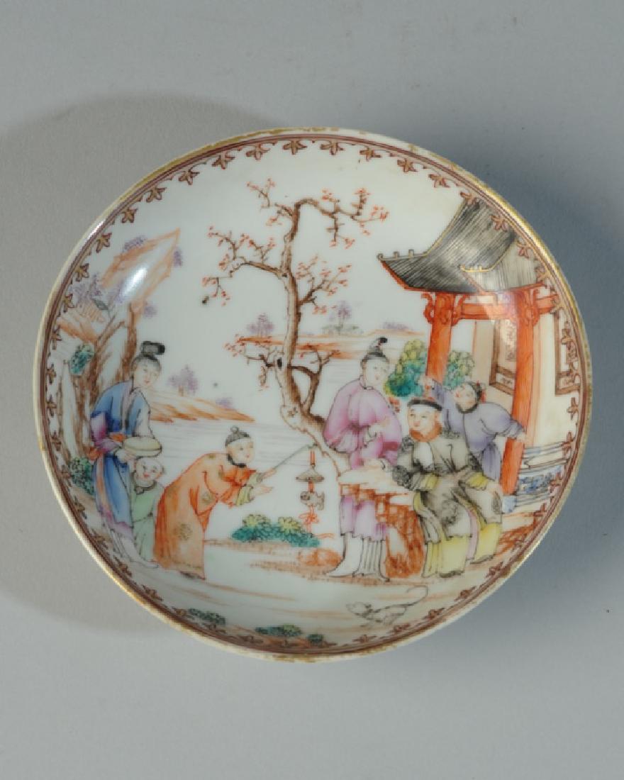 18th C. Chinese Export Porcelain Saucer Dish: Finely painted small dish with a scene of Mandarins near a house in a garden, with a boy holding out a toy to a smiling gentleman in an embroidered robe. The details of architecture, landscape, and cl