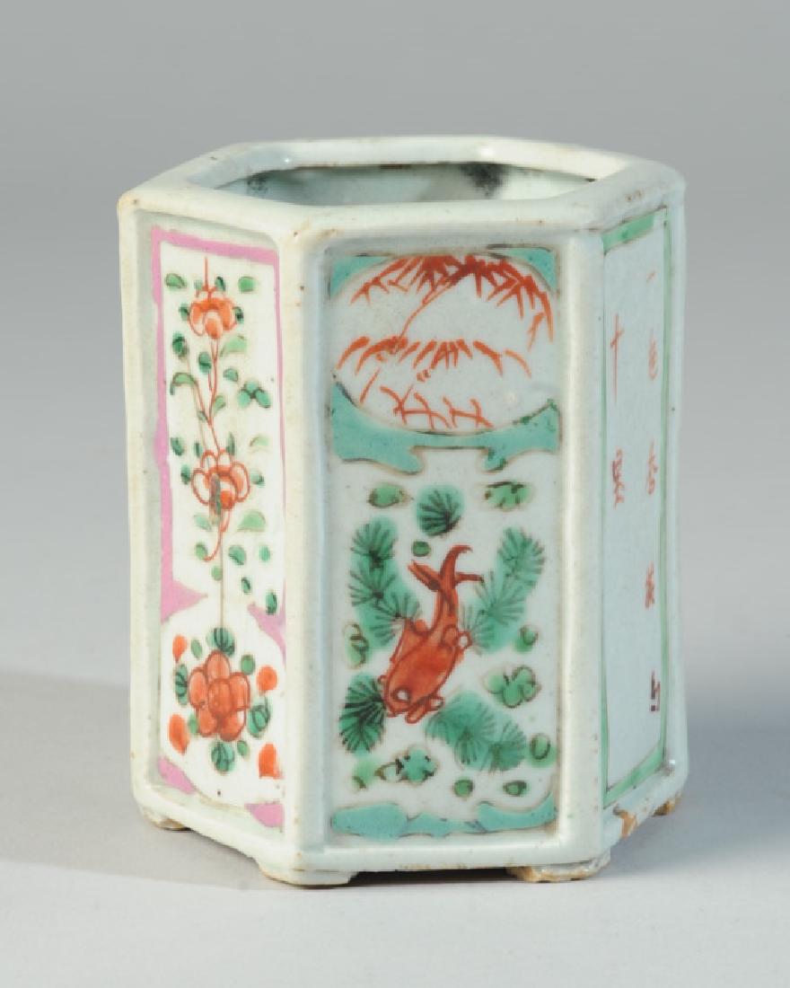 Antique Chinese Hexagonal Brush Pot: Six sided pot with six short feet, the sides with scenes showing a fish under water, a boy running in a garden, two panels with blossoms, and two with calligraphy inscriptions. Qing dynasty period. Ap