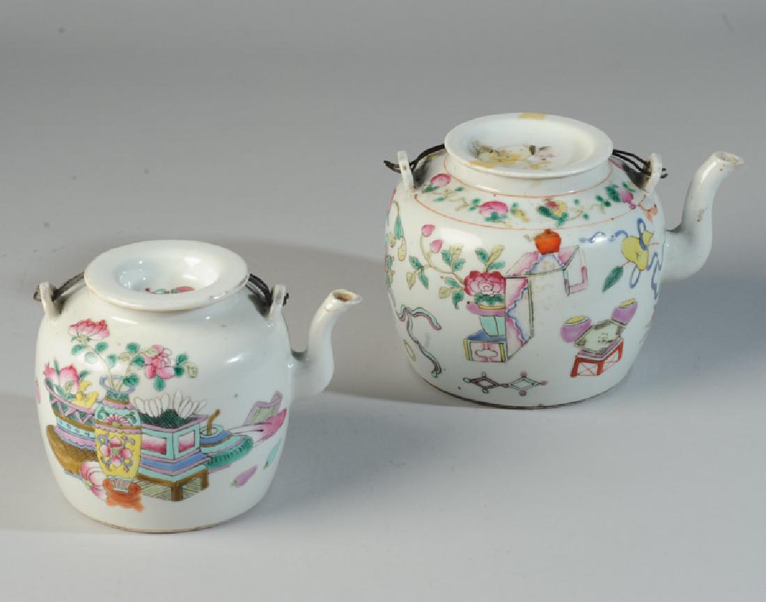 Two 19th C. Chinese Teapots Famille Rose: Larger teapot decorated with "Hundred Antiques" motif, showing flowers, fruit, censer, scrolls, vases, and other auspicious objects. Cover is decorated with a barefoot sage enjoying cherries. Wire han