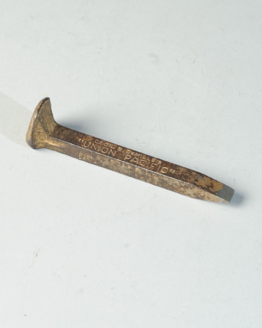 Union Pacific Movie Souvenir: A railroad spike commemorating Cecil B. Demille's "Union Pacific", a Paramount Picture staring Barbara Stanwyck and Joel McCrea. L: approx. 5 1/2".