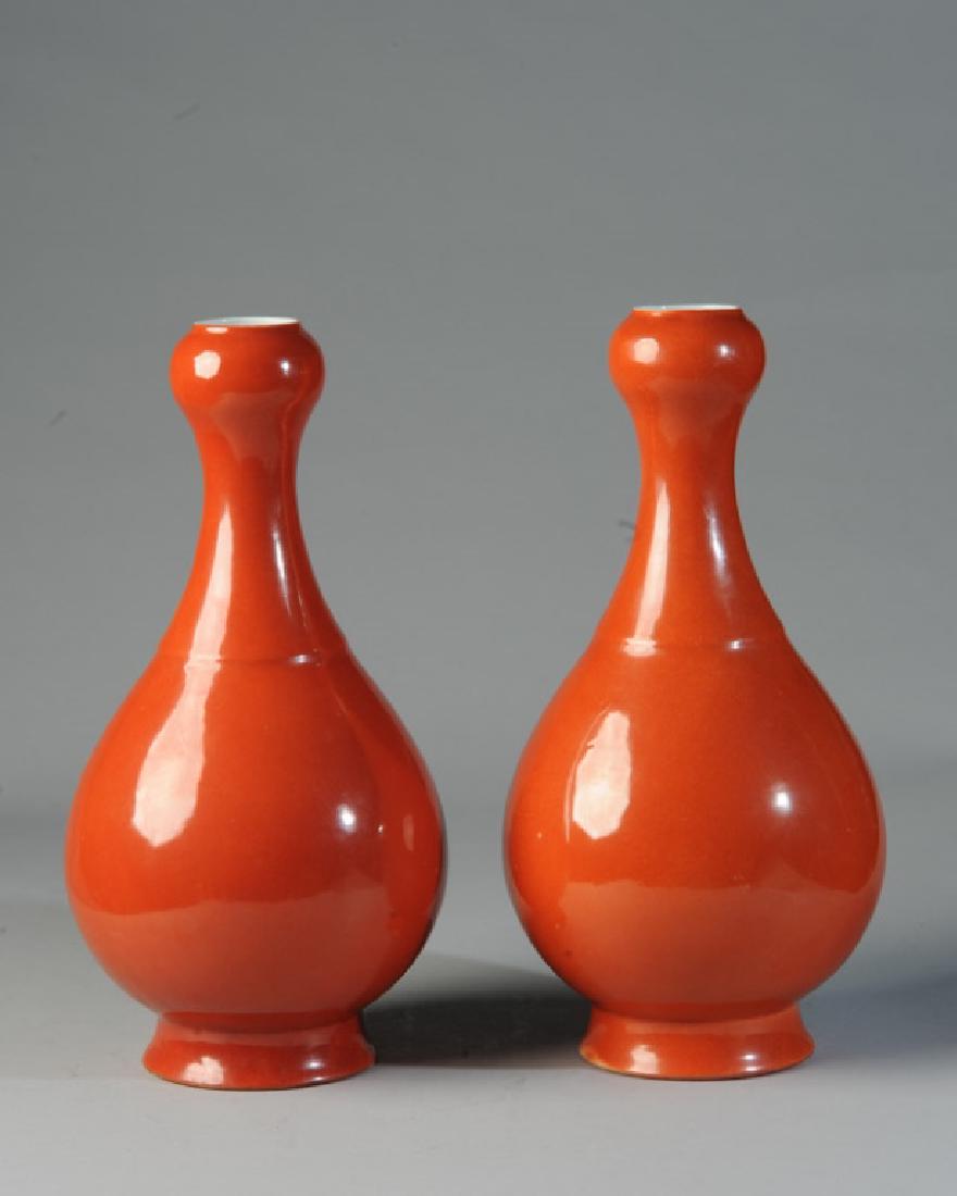 Pair Chinese Coral Red Garlic Head Vases: White interior and base. Unmarked. Very good condition, with a few small surface abrasions (scratches) of the red glaze showing white beneath. Approx 13 1/2" in height.
