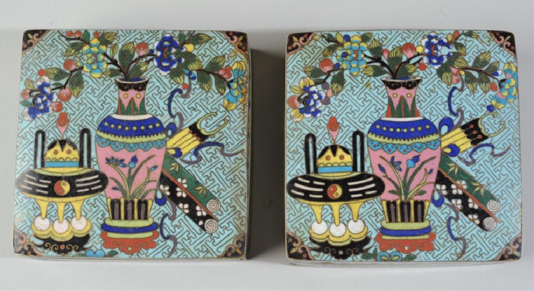 Pair. Chinese Cloisonne Boxes & Covers: Pair of very finely enameled cloisonne covered boxes decorated with censers, vases, scrolls, and other precious objects in delicate colors on a pale blue ground. Sides with blossoms, bases with auspic