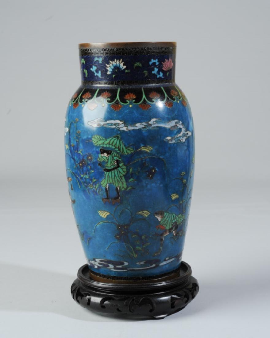 Remarkable Japanese Meiji Cloisonne Vase: Gorgeous color and very fine enamel work combine in a charming design of frogs dressed in lily pads, pulling a lily pad rickshaw inhabited by a frog couple and their frog baby, frogs rushing about car