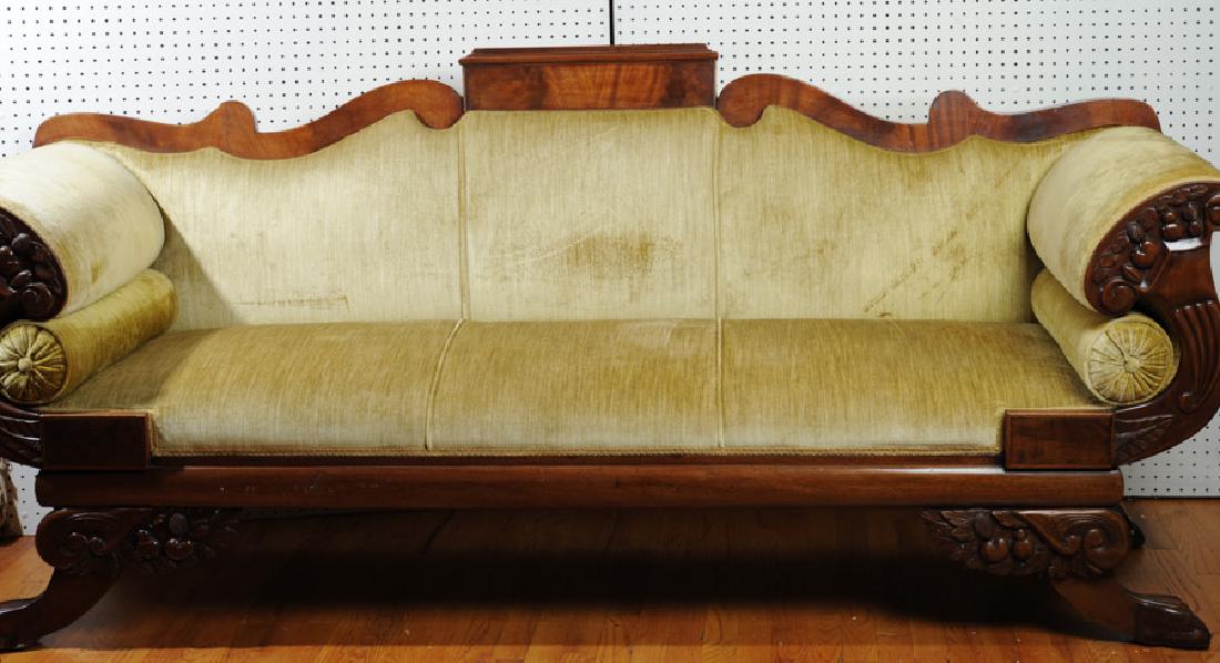 Antique Empire Settee: With moss green velvet upholstery, carved cornucopia arms. H: approx. 37 1/2". W: approx. 83 1/2". D: approx. 26". From the estate of Curtis E. Hagwood of Portsmouth, Virginia.