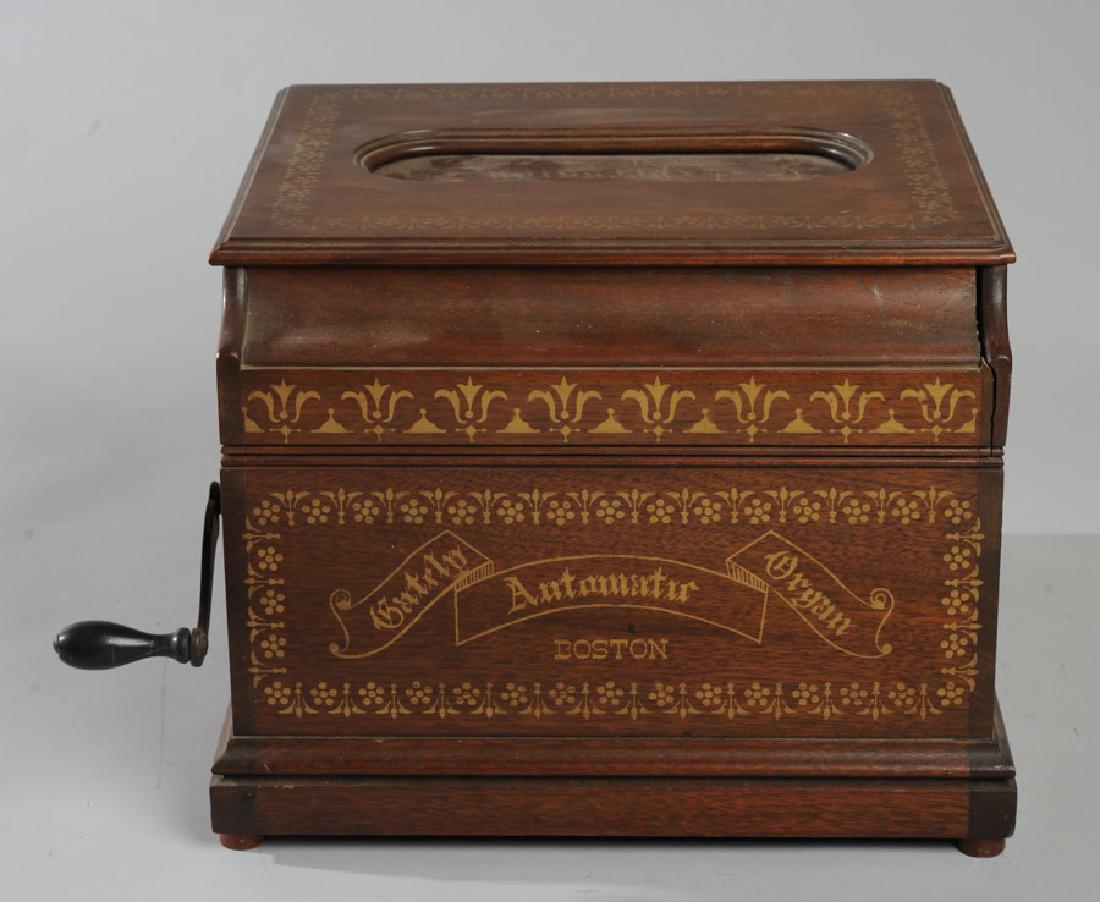 Gately Roller Organ: Marked to lid: "Expression", marked to side: "Gately Automatic Organ Boston", includes paper roll, instructions under lid, lid needs re-gluing. H: approx. 9 3/4".