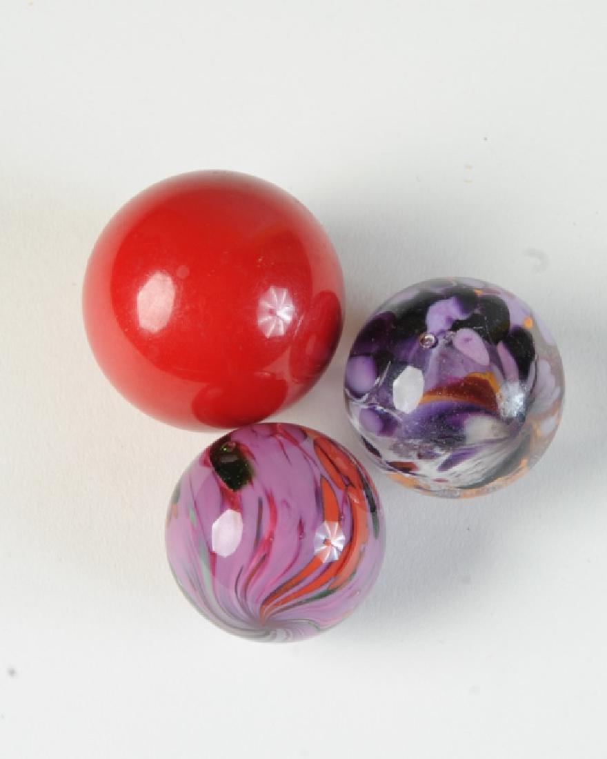 Three Large Marbles: Two multi-colored.