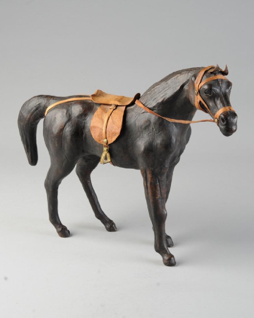 Vintage Leather Toy Horse: With saddle and bridle, original "Made in India" paper label to underside. H: approx. 11 1/4". W: approx. 12".