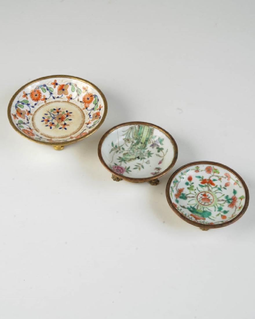 3 Nicholas Haydon Brass Mounted Porcelain Dishes: All with "Nicholas Haydon / 41 West 56th ST N.Y.C." to underside, all showing damage. Largest Dia: approx. 5 3/4". H: approx. 1 3/4".