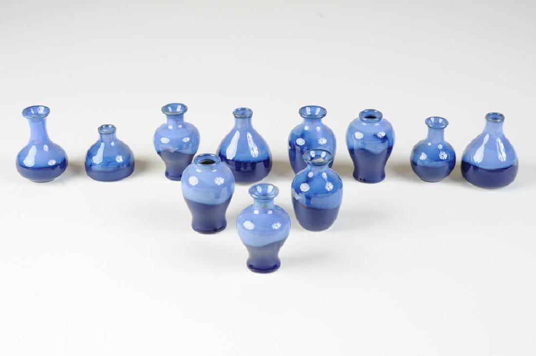 Eleven Garuda Indonesia Pots: These ceramic pots are copies of various antique pots found in Indonesia. Tallest: approx. 2 3/4".