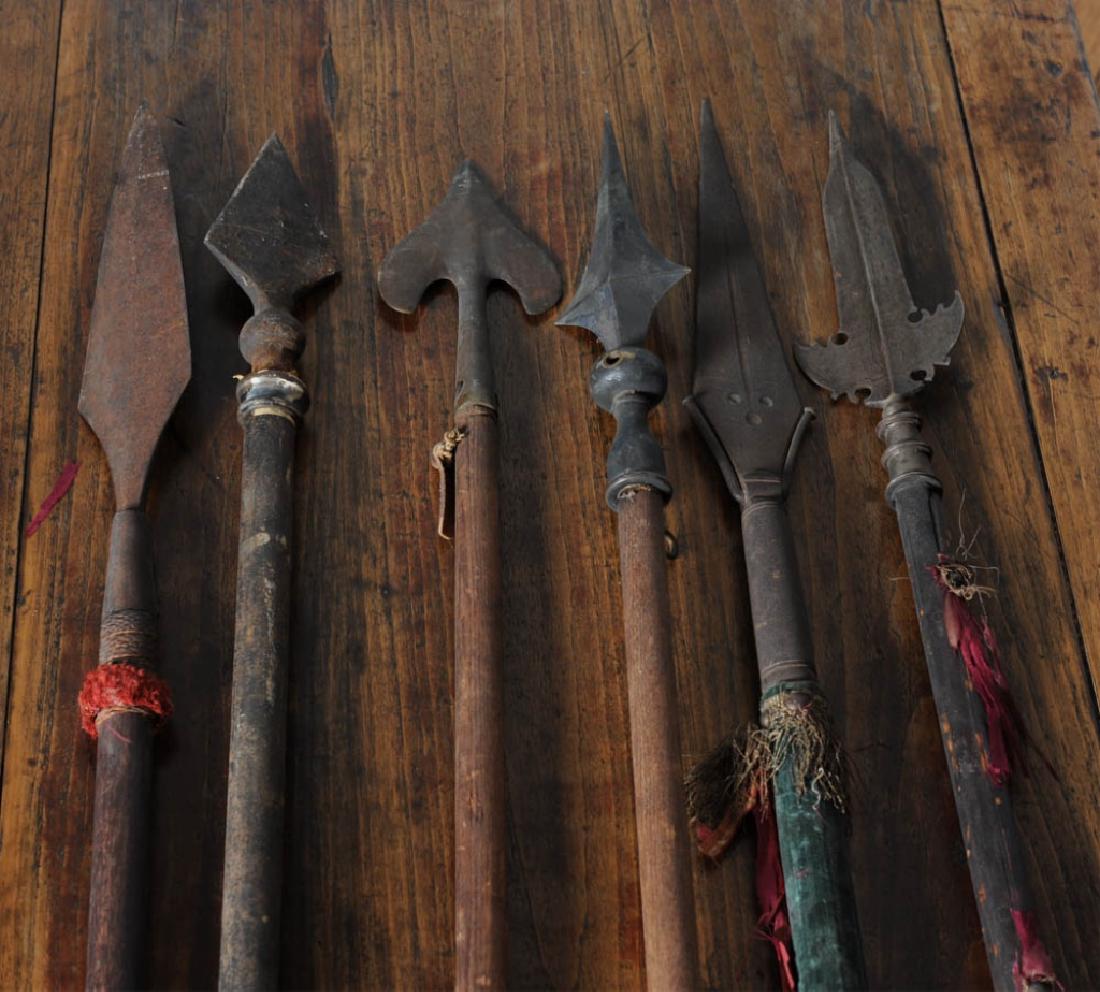 Mixed Lot Antique Flagpoles w/ Finials, Spears: This lot of six poles includes one topped by a medieval type winged spearhead, a Filipino Tausug type spear with rattan wrapped socket, a spear head or finial with Indo Persian / Islamic / North Afric