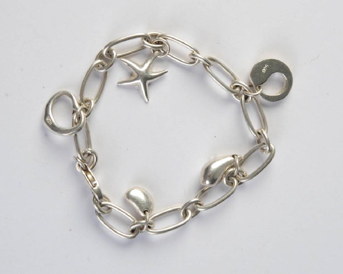 Tiffany Style Sterling Charm Bracelet: With five Elsa Peretti style charms, charms and bracelet latch marked .925. L: approx. 7 1/2". Total weight:: approx. .67 ozt.