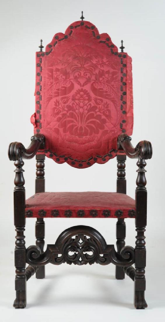 Antique William & Mary Style Spanish Foot Armchair: Silk Damask upholstered high back, heavily carved decorations, Spanish feet, ornate upholstery tacks, brass finials, in as-found condition. H: approx. 59". W: approx. 26". D: approx. 25 1/2". Provenan