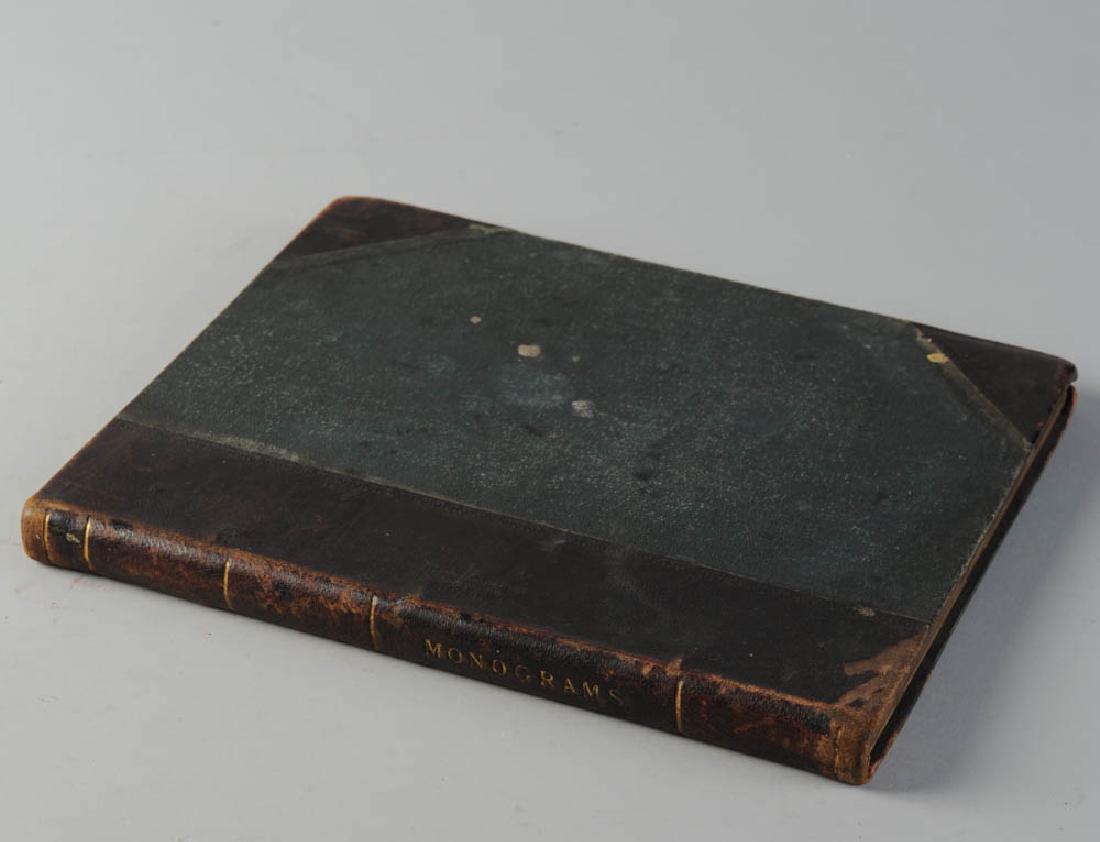 19th C. Coachmaker's Book of Monograms: Sixty plates, no text, showing multiple examples of elaborate monograms, some with heraldry, intended to aid with decorative painting for the exterior of coaches. An 1888 supplement to the "Coach Buil