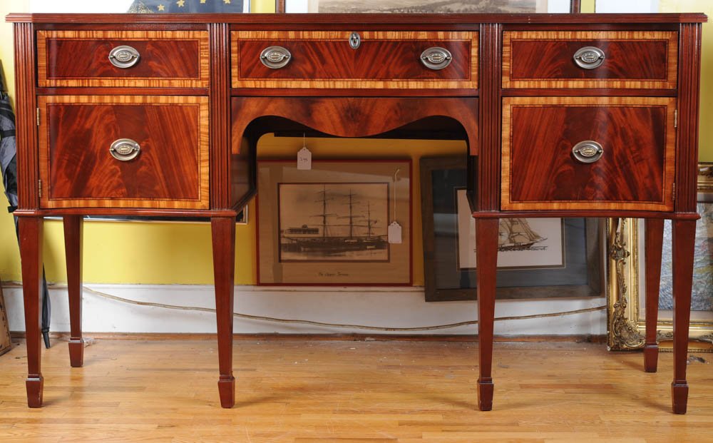 Craftique Federal Style Inlaid Sideboard: Three drawers over two doors, carved skirt, square tapered legs with block feet, "Craftique Makers of Fine Solid Wood Furniture Mebane, North Carolina" labels and brass band to back "Craftique 10381".