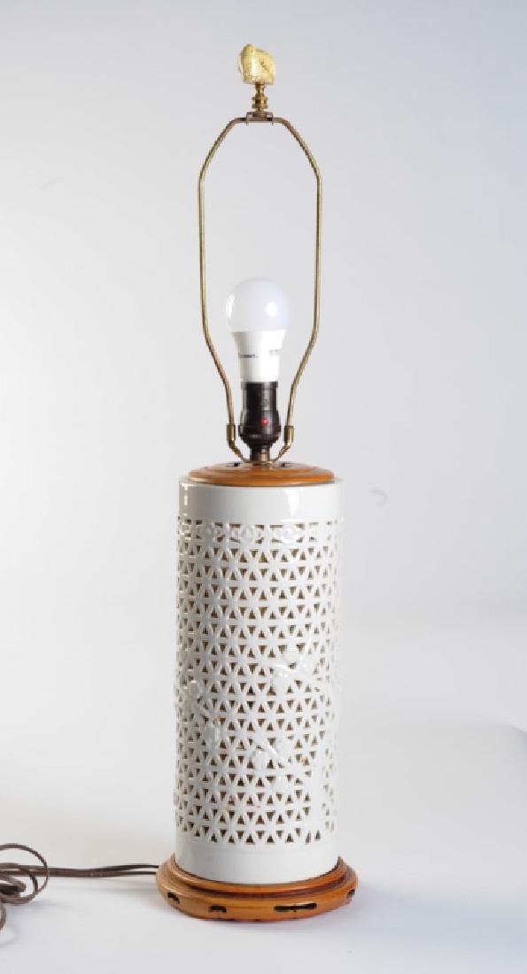 Vintage Japanese Reticulated Porcelain Lamp: Lamp base is reticulated blanc de chine porcelain Japanese lantern; the rice paper lining allows soft warm light to show through the triangular perforations in the porcelain when illuminated. Porcelai