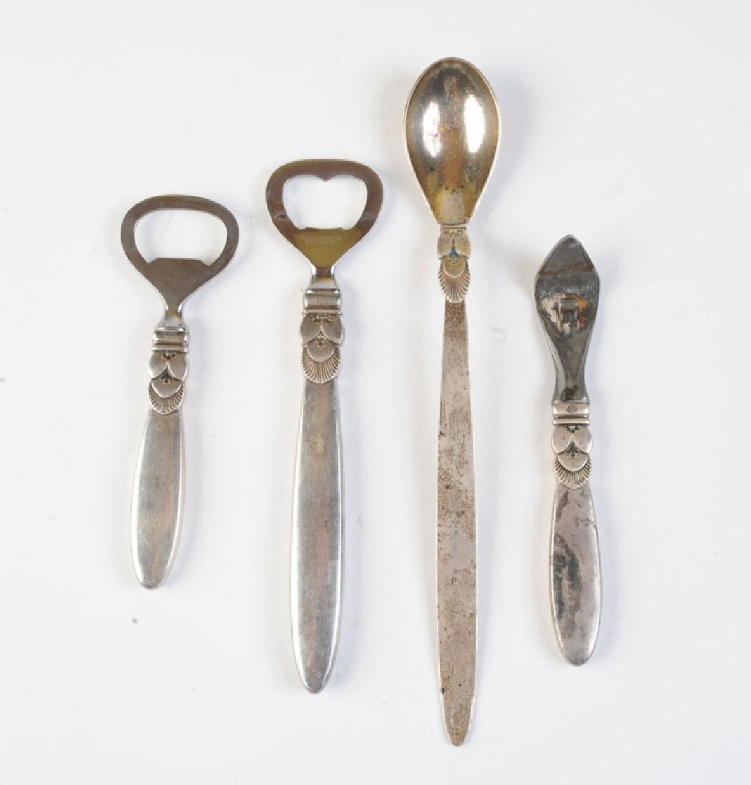 Georg Jensen Sterling Bar Tools: Set of four vintage signed Georg Jensen Denmark bar tools in the "Cactus" pattern, including a 6 1/2" and a 4 1/4" bottle opener, a 5" can opener, and an 8 1/4" bar spoon / muddler. All pieces marked
