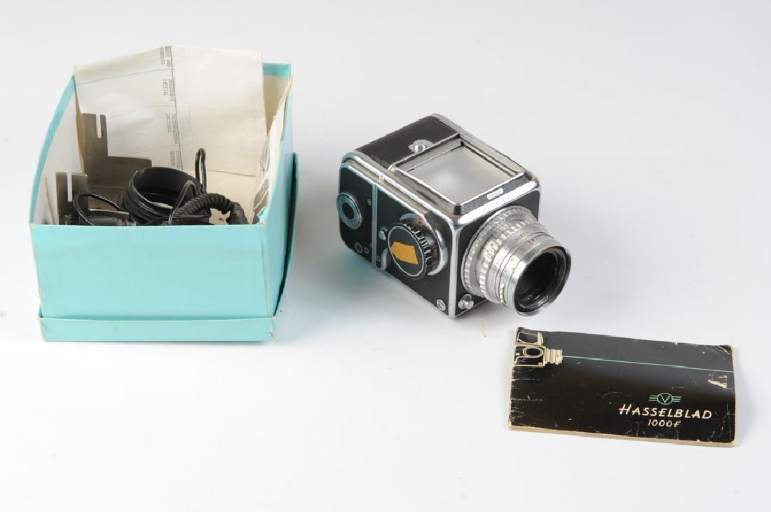 Hasselblad 1000F Camera: With 80mm F2.8 Eastman Kodak lens. With various parts & accessories. As found in an old Tiffany & Co box. Provenance: From the estate of Dr. Milton T. Edgerton (1921 - 2018.) A trailblazing plastic su
