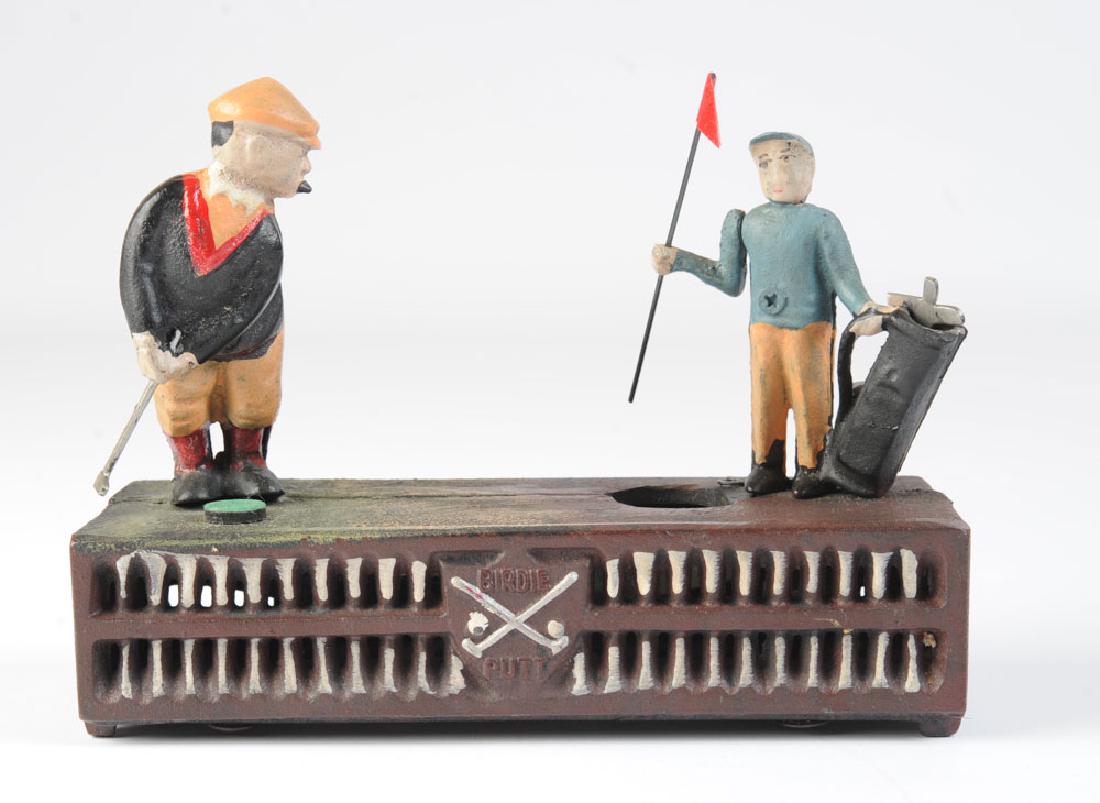 Cast Iron Golf Bank Birdie Putt: Desk top golf game bank. Label for "Upper Deck" Co. Aprox. 8 1/4" x 6 1/2" x 3". Provenance: From the estate of Dr. Milton T. Edgerton (1921 - 2018.) A trailblazing plastic surgeon, Dr. Edgerton joine