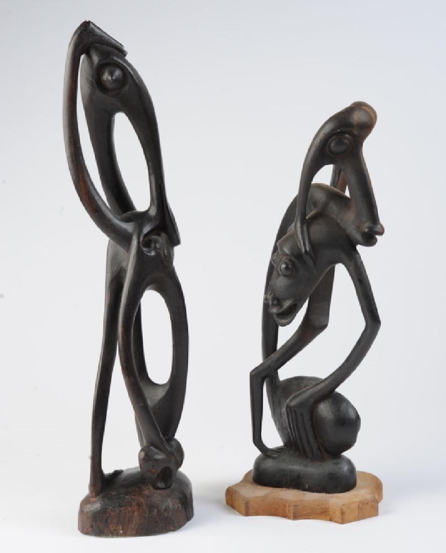2 Carved African Makonde Spirit Sculptures: Pair carved wooden Shetani sculptures made by artisans from the Makonde tribe of Tanzania. Surreal distorted openwork figures with a modernist look. Dark hardwood, probably ebony. Approx. 21" and 16 1