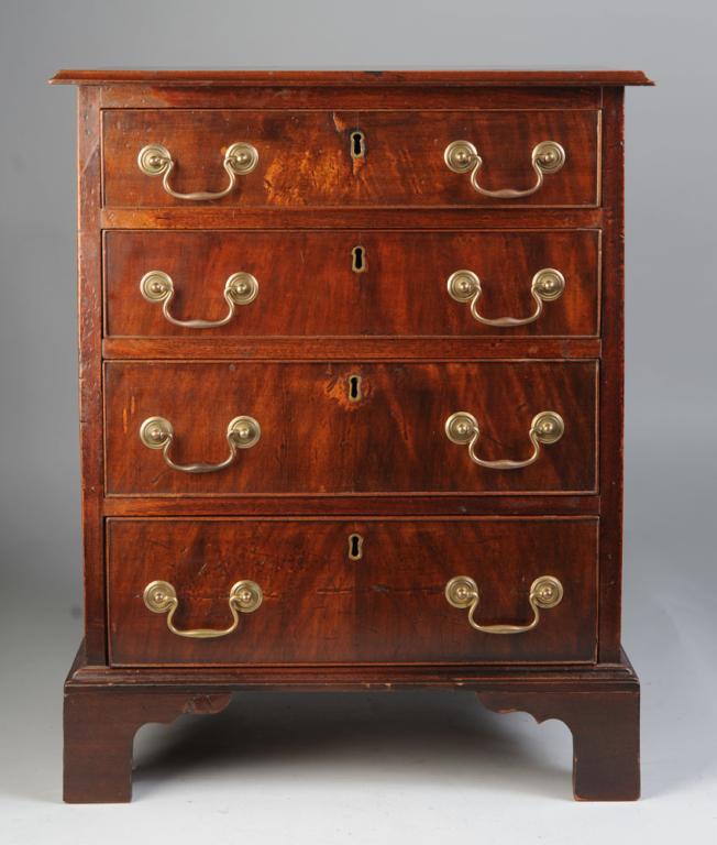 Diminutive Chippendale Style Chest of Drawers: Molded-edge top over four cockbeaded drawers with brass escutcheon and pulls over bracket feet. H: approx. 26 1/2". W: approx. 21 1/2". D: approx. 15".