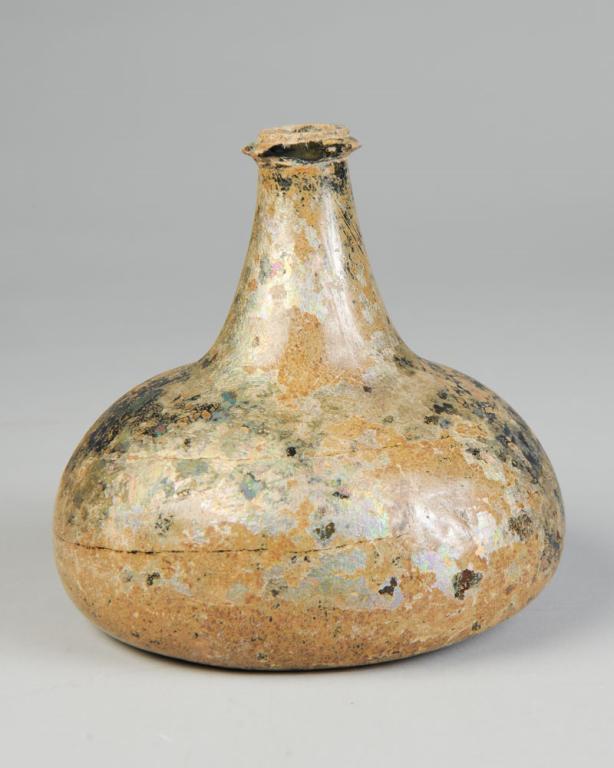 17th-18th C. "Onion" Wine Bottle, Iridescent: With applied string lip, pontil scar, original untouched gold and rainbow iridescent surface. Likely English or Dutch. Chips to string portion of lip. Approx. 6 1/4" in height, 5 3/4" diameter. Proven