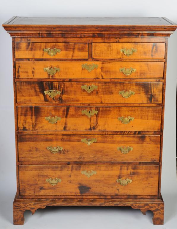 18th C. New England Chest of Drawers: C. 1770-1780 chest, figured maple with chestnut and with pine secondary. Top with deep molded cornice above two over five graduated drawers. Replaced ogee bracket feet. Approx. 50 3/8" H x 40" W x 19 