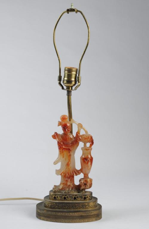 Chinese Carved Hard Stone Guanyin Lamp: Carved figure of Guanyin, goddess of compassion, with water jar and willow branch. Break /loss to section of willow branch. Figure with ormalu brass mount, stepped base. Total height, approx. 20". Fig