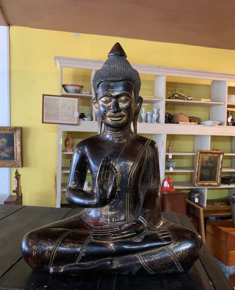 Asian Carved Wooden Buddha: Seated with hands in Vitarka Mudra. Black lacquer and gilt finish. 20th C. Approx. 17 1/2" in height.