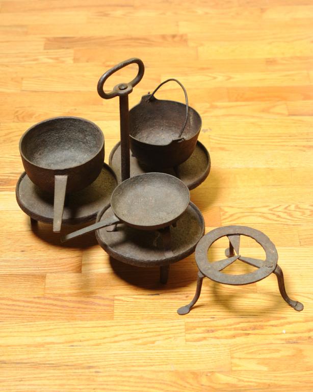 Lot 18th 19th C. Hearth Cooking Iron Implements: Including early wrought iron triple griddle with long upright handle, two early iron trivets, three small iron posnet pots. Triple griddle, approx. 15" wide, 14" high.