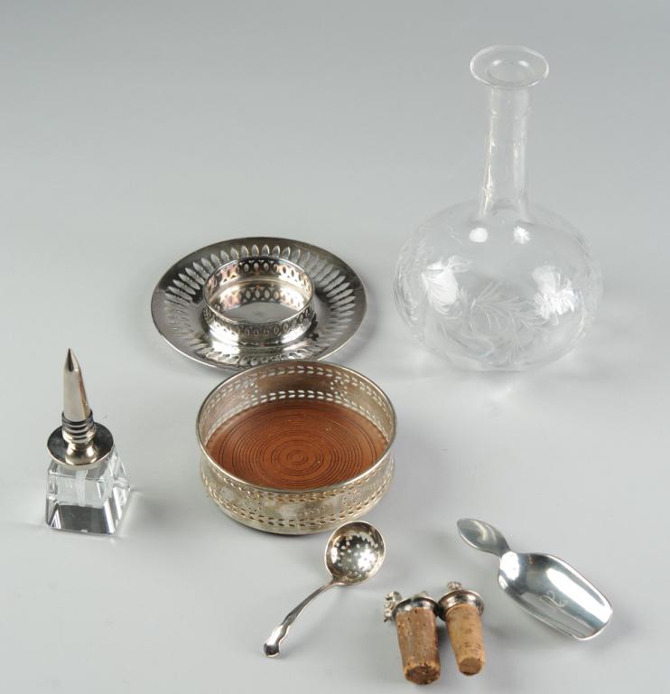 Bar Lot: Glass Decanter, Wine Coasters, Stoppers +: Hand blow glass decanter with delicate cut design, polished pontil and with unidentified acid etched mark with fleur de lis between two birds within clover shaped border. Offered together with etched