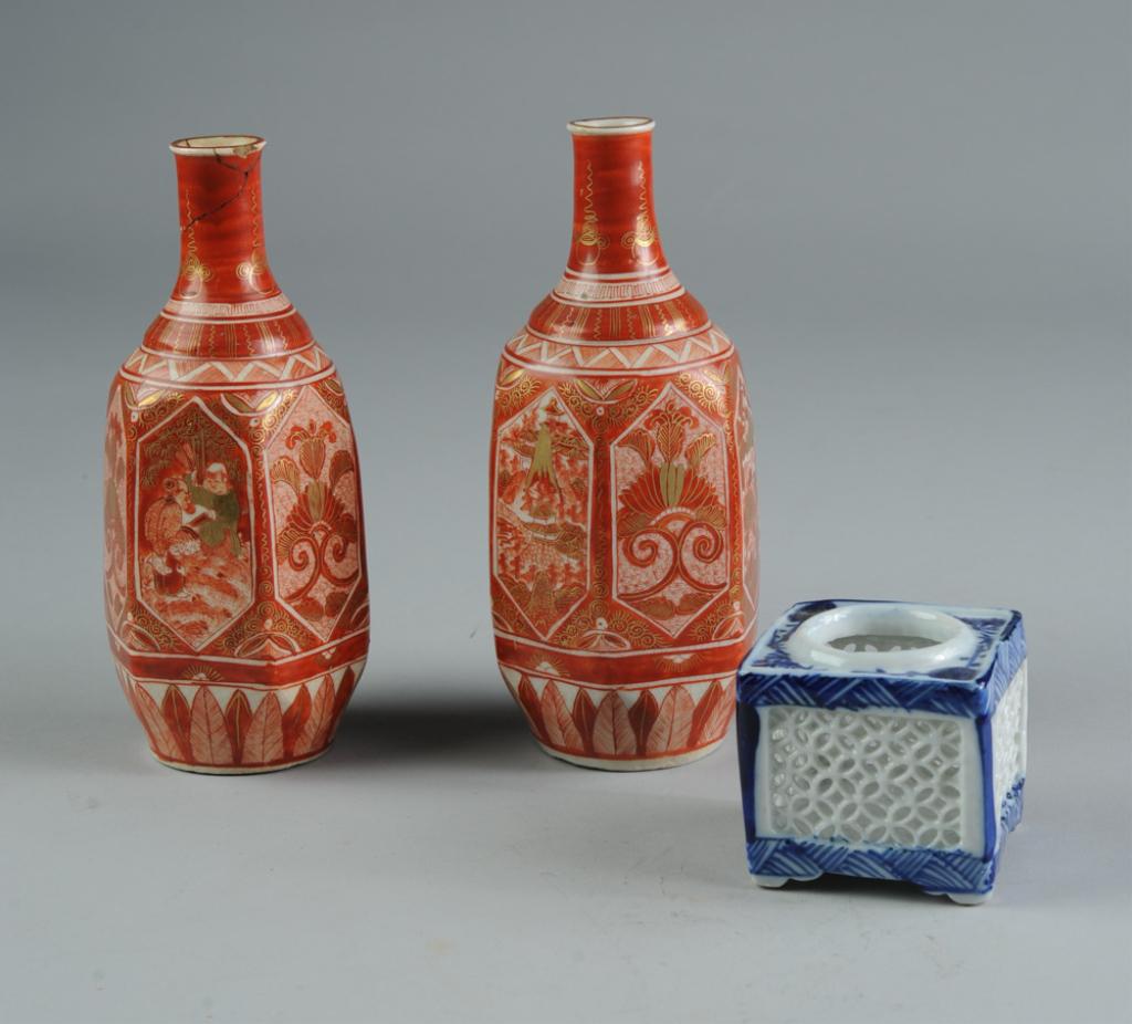 Antique Japanese Porcelain: Kutani, Hirado: Pair of 19th C. Kutani sake flasks, with six faceted sides and unusually fine red and gold hand painted decoration, offered together with a reticulated square Hirado koro (censer) with decoration in u