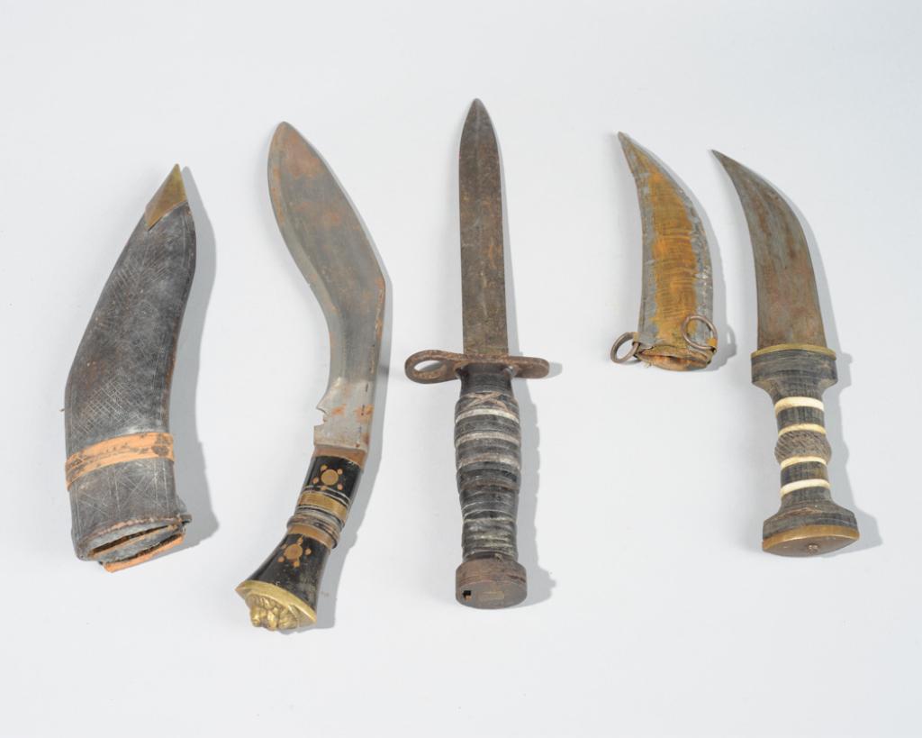 Vintage Knife Lot: Kukri, Jambiya, Bayonet: To include a Gurkha lion head kukri in incised leather sheath, a Middle Eastern Jambiya, the wood hilt inlaid with bone, mother of pearl and copper, and with incised copper sheath, and a bayonet with 