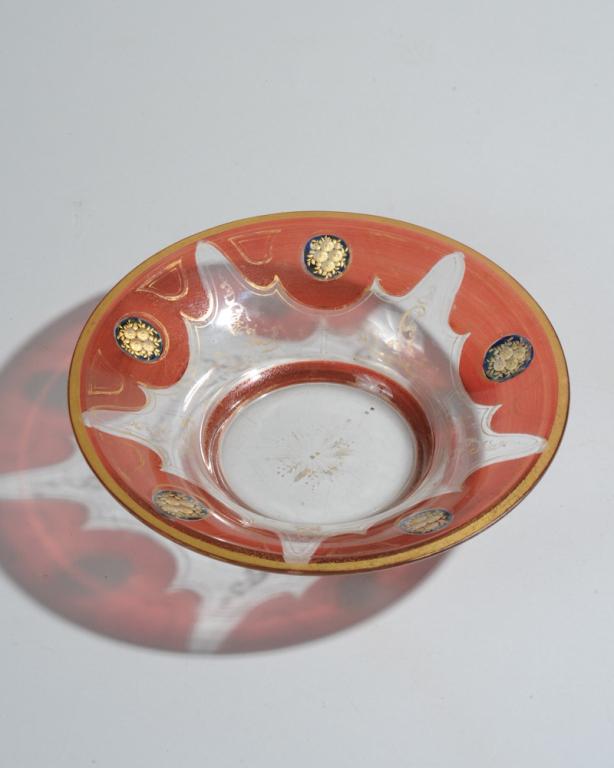 Antique Cranberry & Gold Cut Glass Bowl: Probably Czech. Medallions with floral bouquets cut to the underside of the glass and gilded appear to float on ruby or cranberry swags, with overglass gold decoration, much of the latter worn away. A