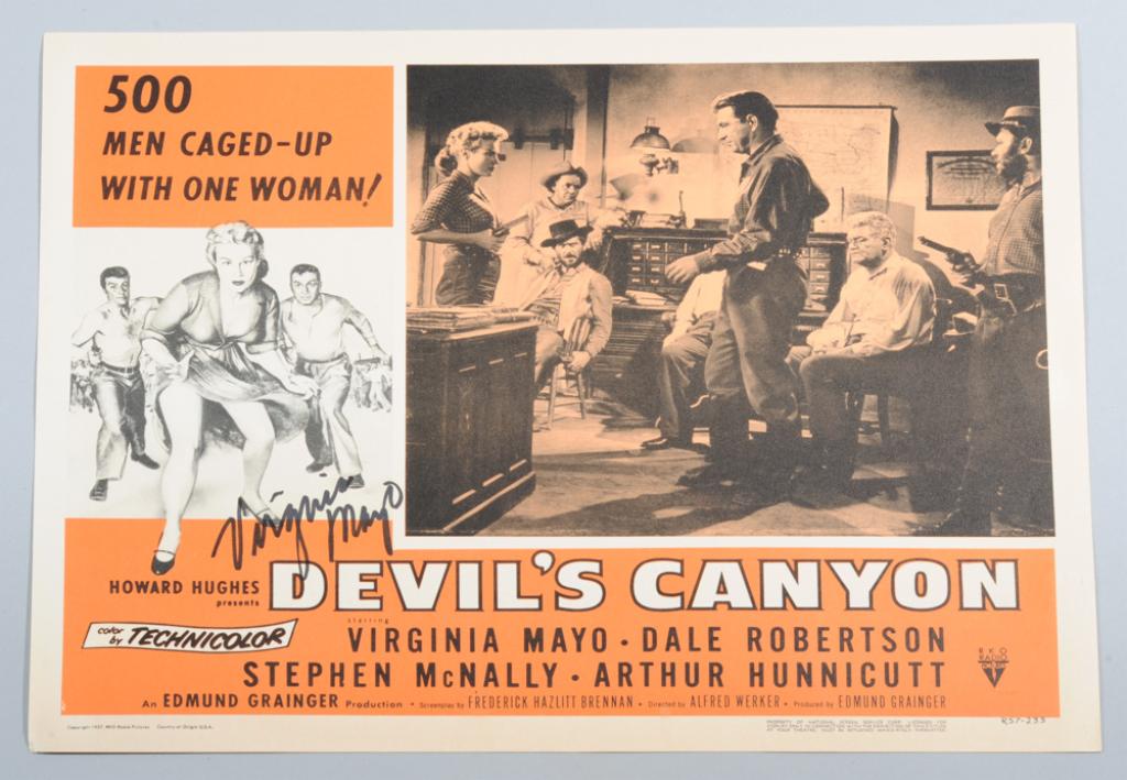 Virginia Mayo (1920 - 2005) Autographed Lobby Card: Lobby card for 1957's Devil's Canyon ("500 Men Caged-Up with One Woman!") signed by actress Virginia Mayo, in as-found condition. Approx. 14" x 11".