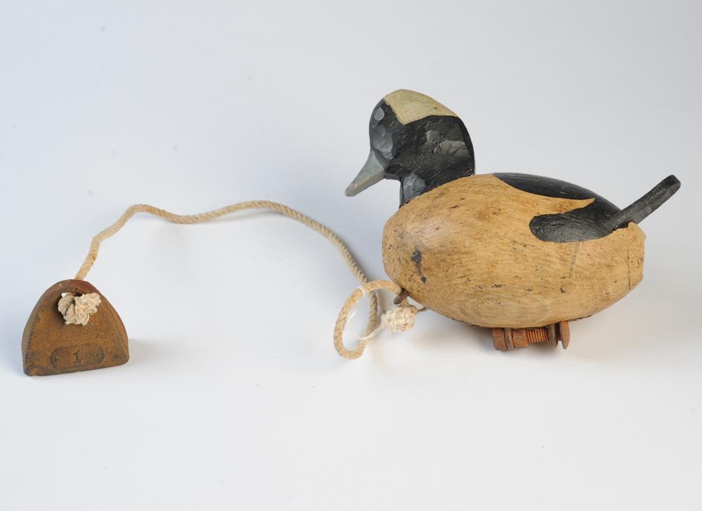 R. Wade Signed Carved & Painted Decoy: Signed R. Wade to underside (Ron / Ronnie Wade of Knots Island, NC), with attached weight, in as-found condition. H: approx. 5". L: approx. 7".