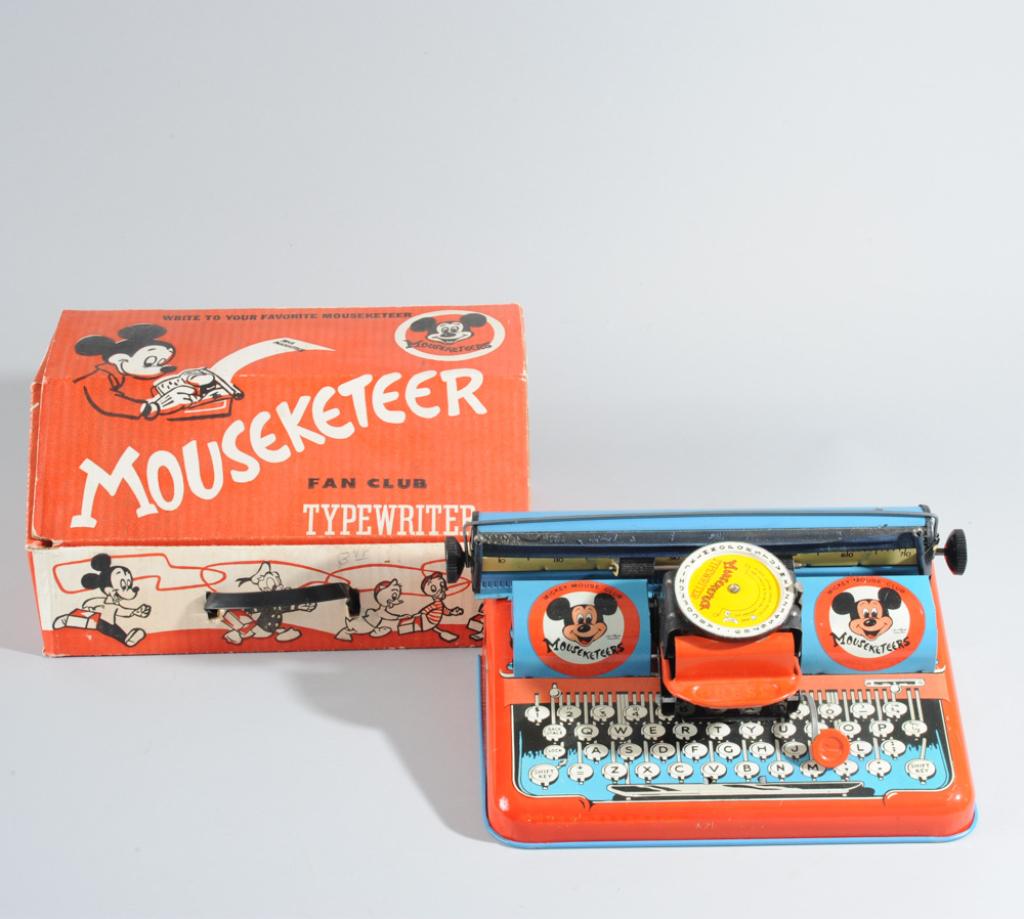 Mid Century Walt Disney Tin Typewriter: Marked Mickey Mouse Club, in original Mousekateer Fan Club box. H: approx. 4 3/4". W: approx. 11". D: approx. 6 1/2".
