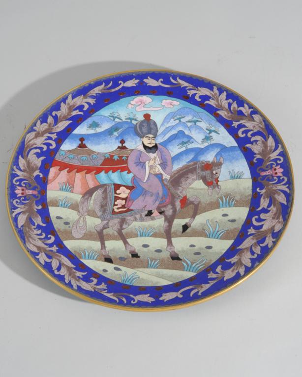 Unusual Chinese Cloissonne Plate: A Mongol on horseback, cobalt blue and floral rim, unmarked. Dia: approx. 12".