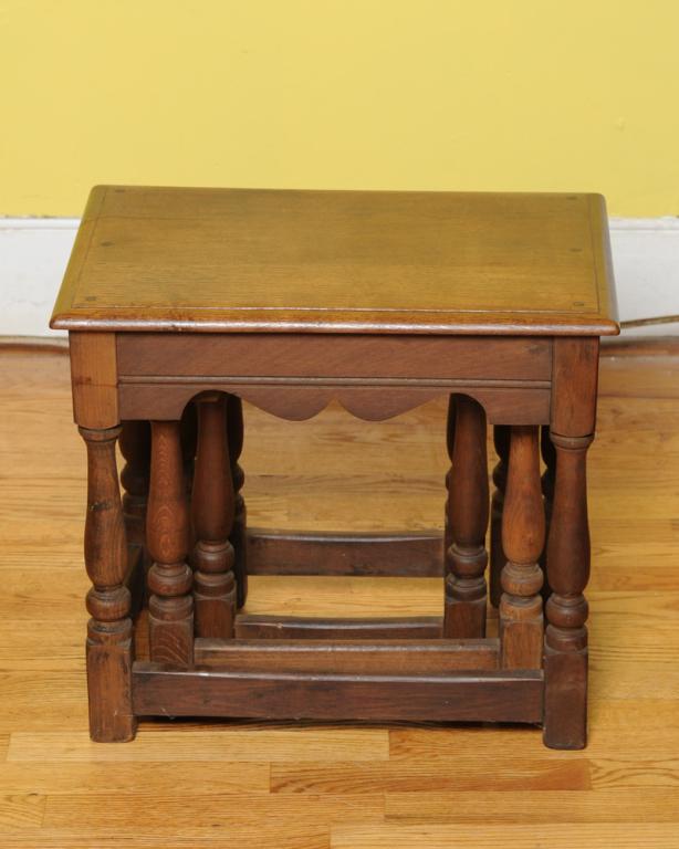 Set of Three English Oak Nesting Tables: Rectangular top with shaped apron, turned legs with stretchers, block feet. Largest: H: approx. 18 1/2". W: approx. 20 3/4". D: approx. 13 1/2".