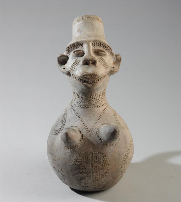 Mangbeto Figural Palm Wine Vessel: Anthropomorphic terracotta vessel for palm wine in the form of a female figure. Mangbeto people, Democratic Republic of Congo. Approx. 12 1/2" in height. Provenance: Estate of Thomas McNemar, (1931-20