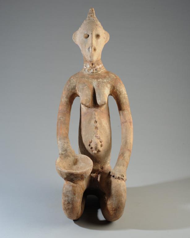 Djenne Terracotta Female Figure: Seated Djenne type pottery female figure with bowl, Mali. Head appears to be heavily restored. We cannot verify the age of this figure. Approx. 27" in height. Provenance: Estate of Thomas McNemar, (19