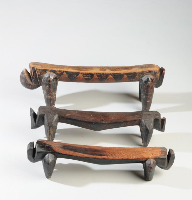 Three Dinka Headrests, Sudan: Abstract zoomorphic forms, carved wood with dark pigment. Largest, approx. 18" long. Provenance: Estate of Thomas McNemar, (1931-2019.) McNemar lived and collected throughout Central and West Africa i